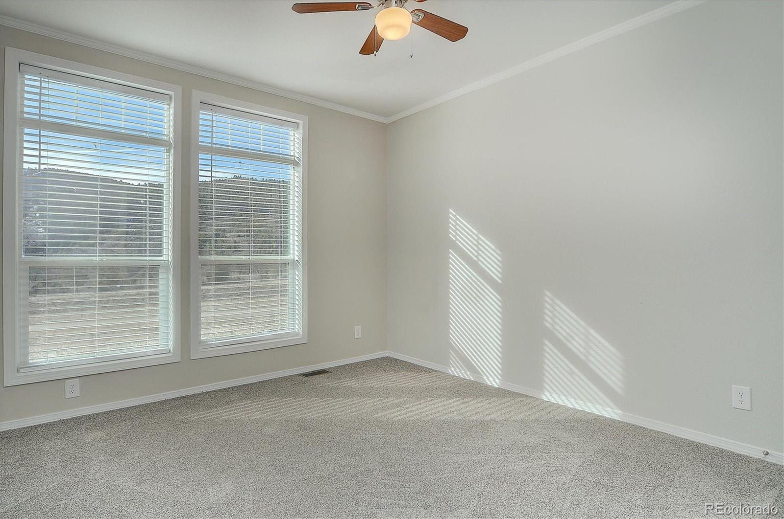 16554 Rocky Mountain Road Salida, CO 81201 - Photo 17 of 33 an empty room with chandelier fan