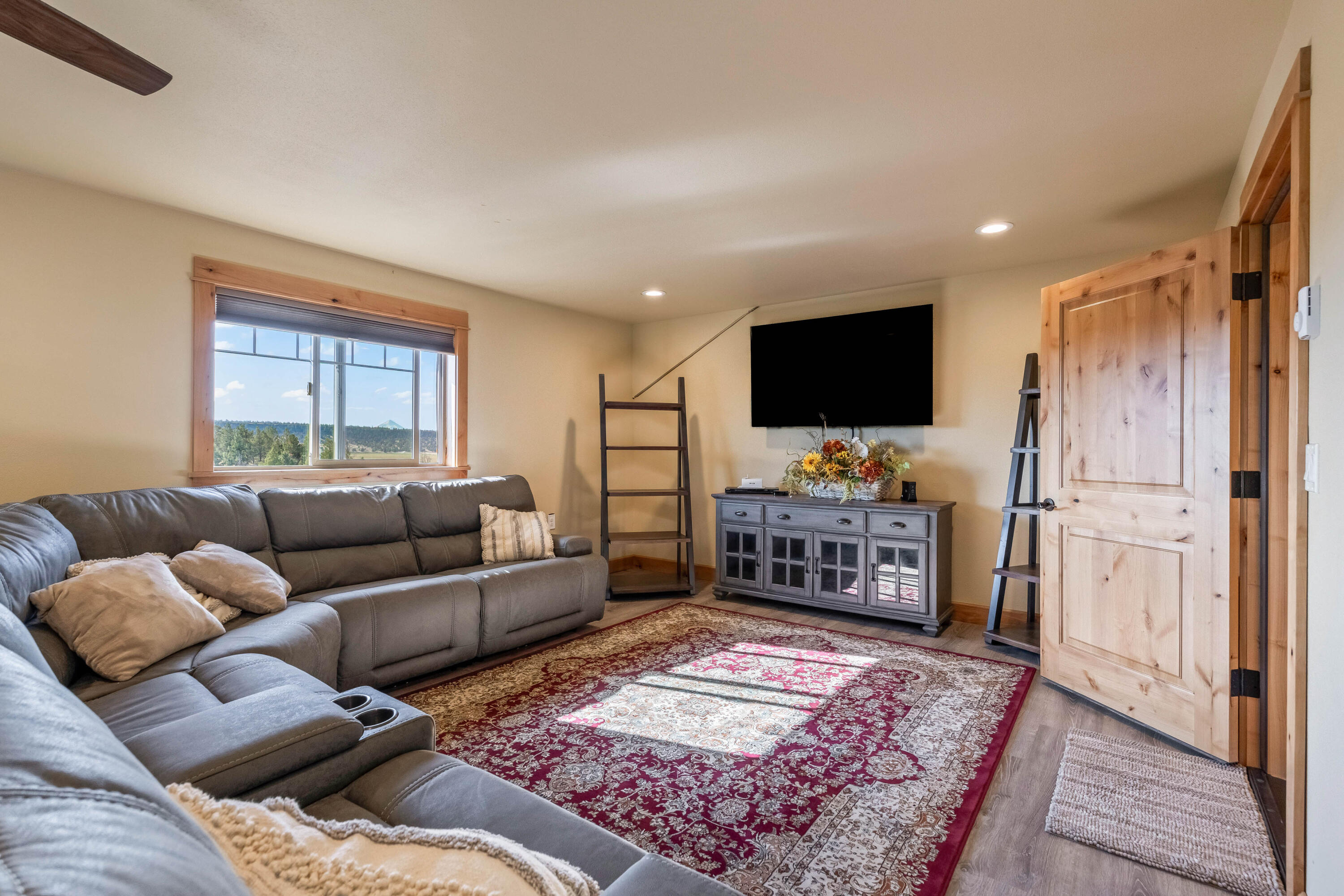70030 Northwest Hunt Road Sisters, OR 97759 - Photo 26 of 55 a living room with furniture and a flat screen tv