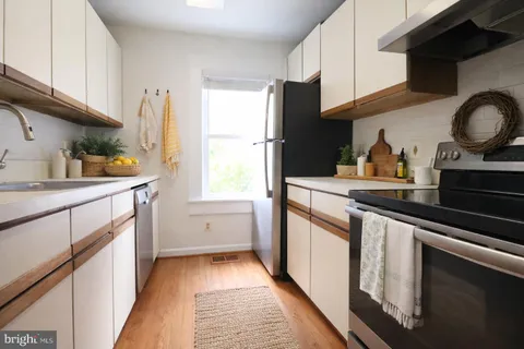 a kitchen with a sink stove and refrigerator