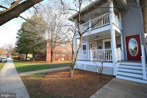 a view of a brick house with wooden fence