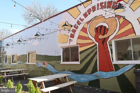 a man walking down a street next to a building