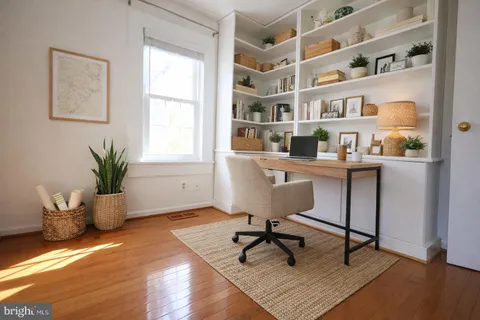 a workspace with furniture and a potted plant