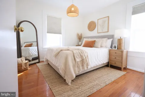 a bedroom with a bed and a mirror