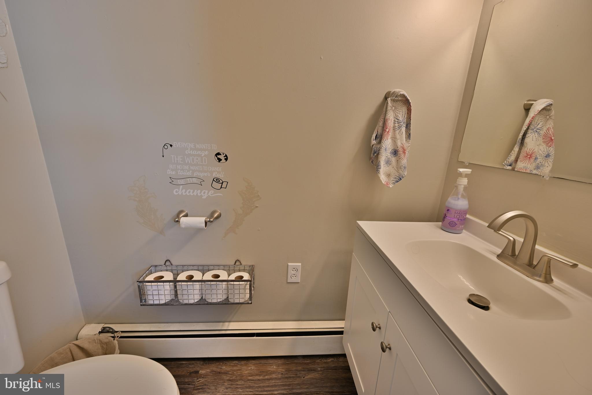 24734 East Main Street Columbus, NJ 08022 - Photo 10 of 24 a bathroom with a toilet sink mirror and vanity