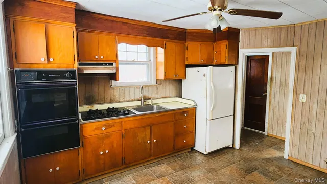 a view of an empty room with a fireplace and a window