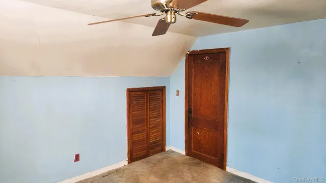 an empty room with a window and a chandelier