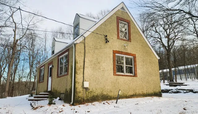 a view of a house with snow on the road