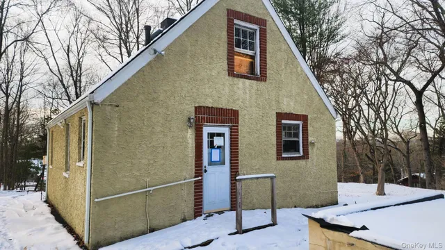 a backyard of a house with table and chairs