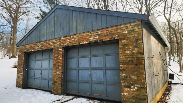 a view of a house with a door and wooden walls