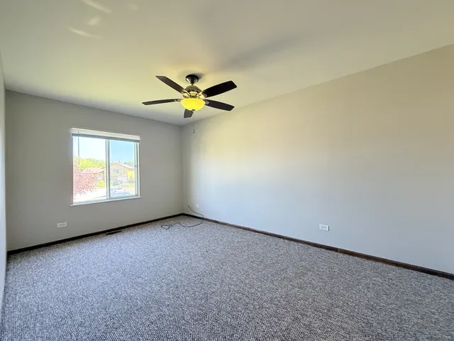 a view of empty room with ceiling fan