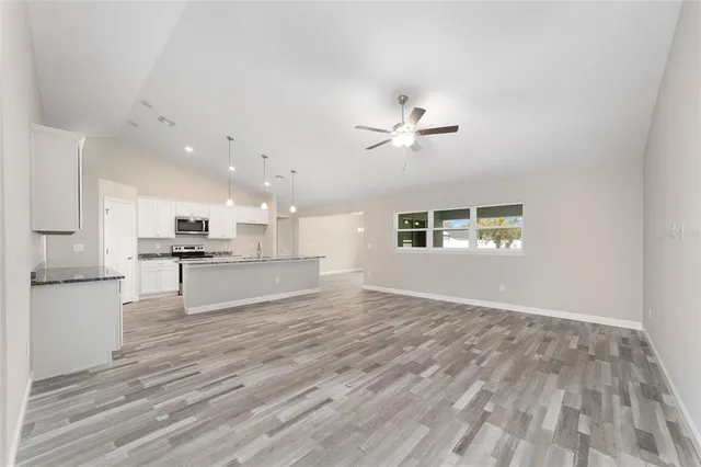 a view of kitchen with cabinets and wooden floor