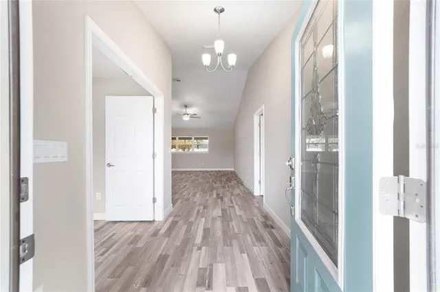a view of a hallway view with wooden floor and staircase