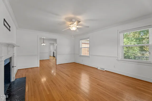 an empty room with a empty space and a ceiling fan