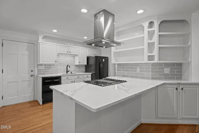 a front view of a house with a garden and plants