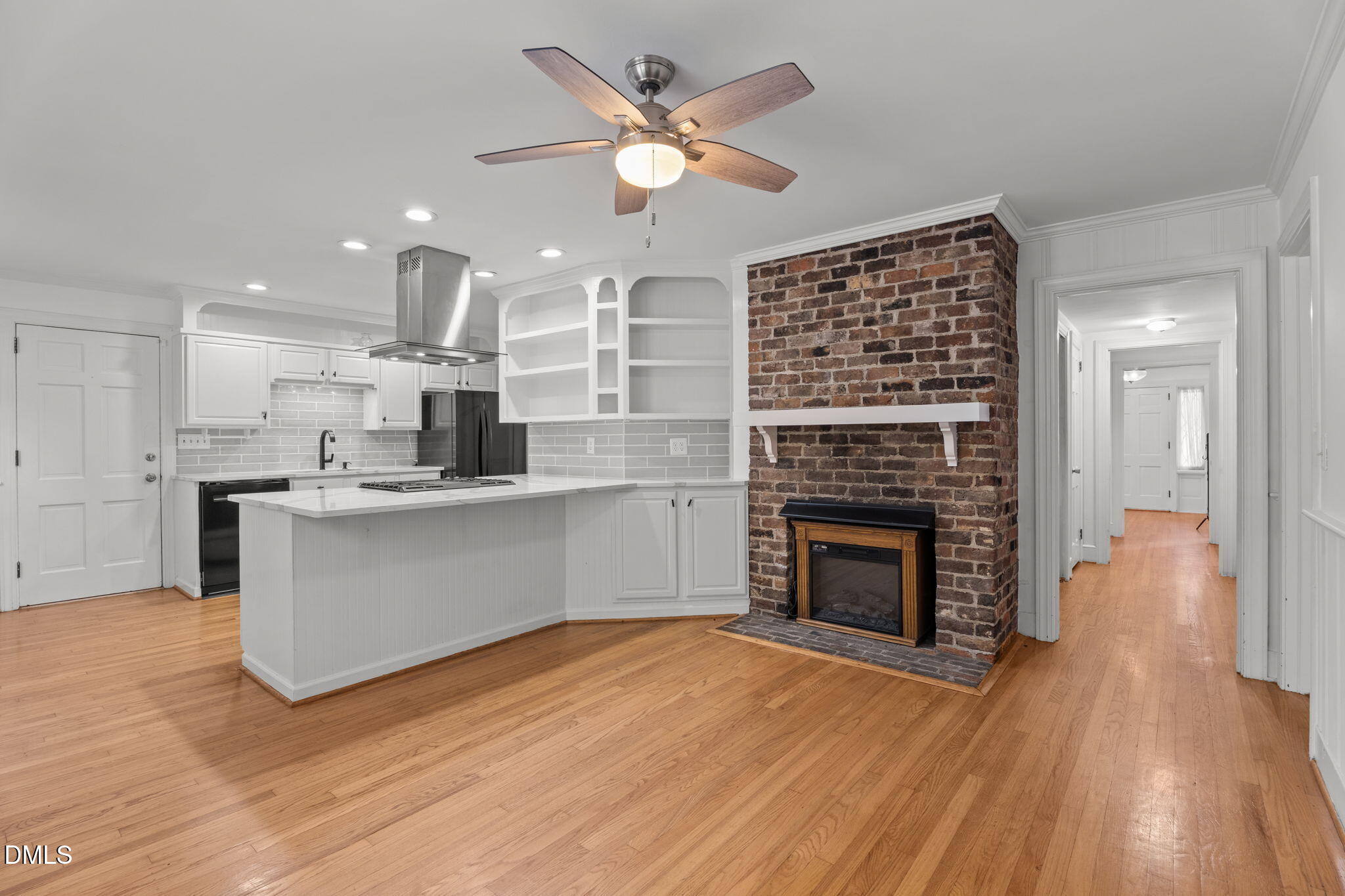 215 East Branch Street Spring Hope, NC 27882 - Photo 26 of 61 a living room with stainless steel appliances kitchen island a fireplace and a ceiling fan