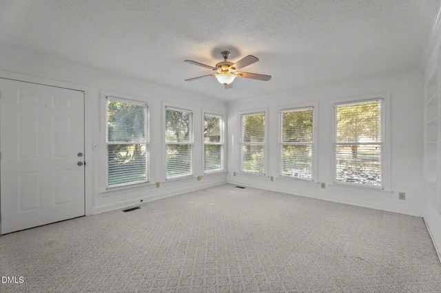 a view of a backyard with plants and a bench