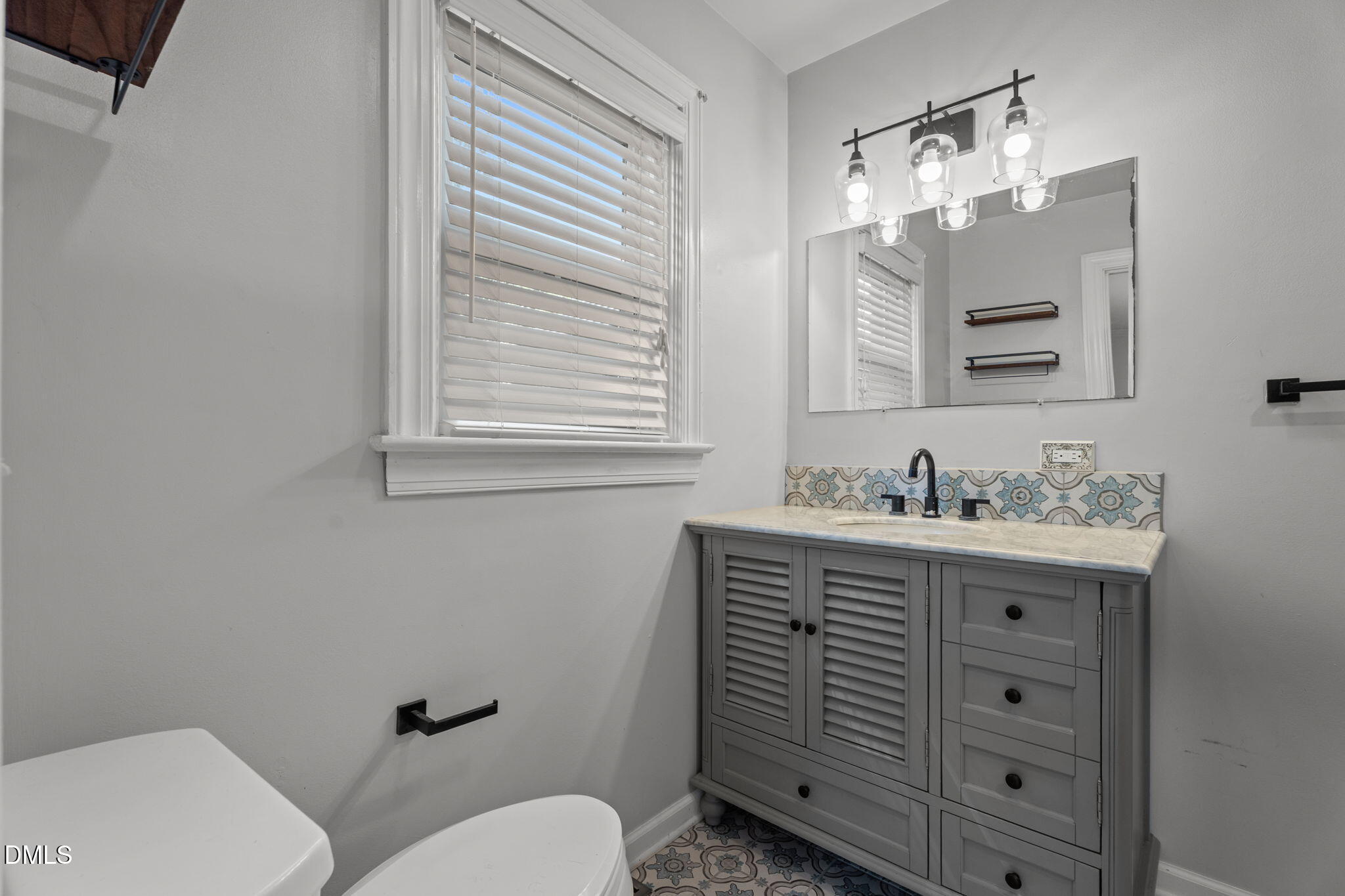 215 East Branch Street Spring Hope, NC 27882 - Photo 36 of 61 a bathroom with a sink vanity mirror and toilet