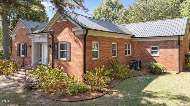 a view of empty room with a fireplace and wooden floor
