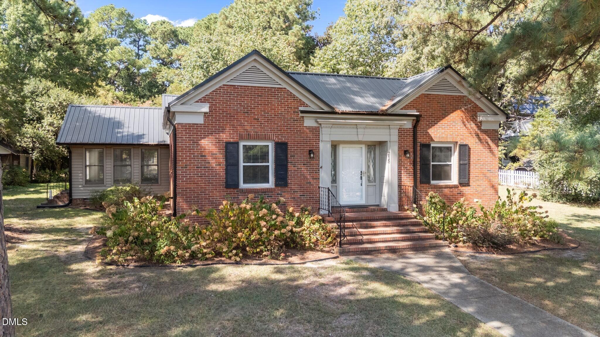215 East Branch Street Spring Hope, NC 27882 - Photo 9 of 61 a front view of a house with a yard and garage