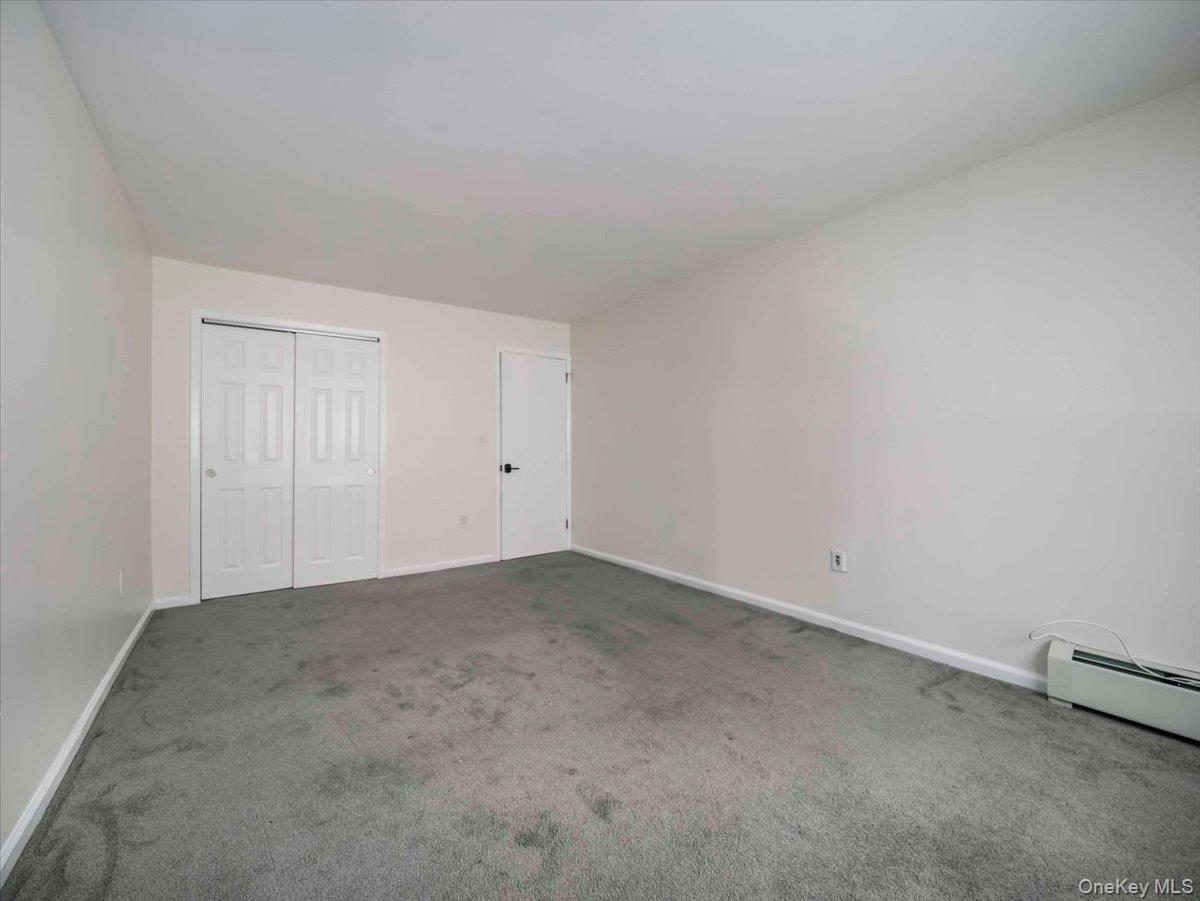 27 Tanager Road, Unit 2702 Monroe, NY 10950 - Photo 21 of 35 Spacious room featuring neutral carpeting, light-toned walls, and white trim
