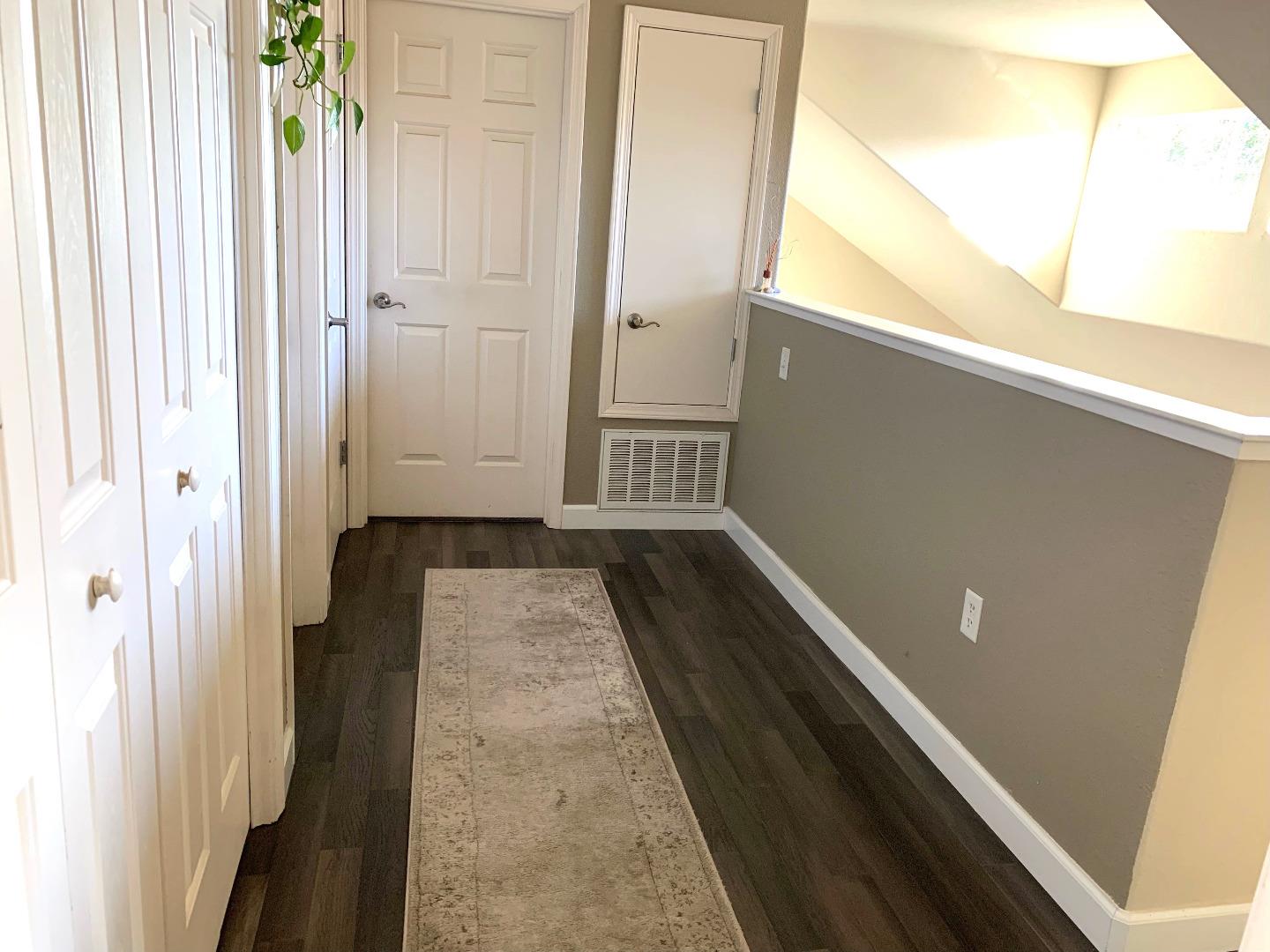 1530 Rosette Way Gilroy, CA 95020 - Photo 5 of 12 a view of a hallway with wooden floor and staircase
