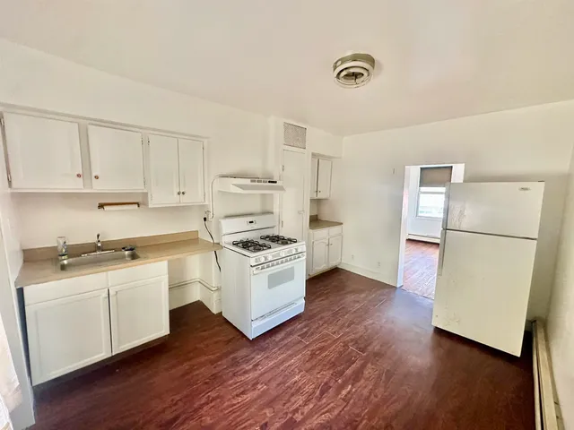 a kitchen with a white cabinets and white appliances