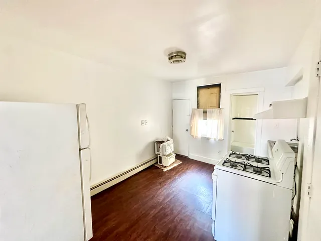 a kitchen with stainless steel appliances a refrigerator and a stove top oven