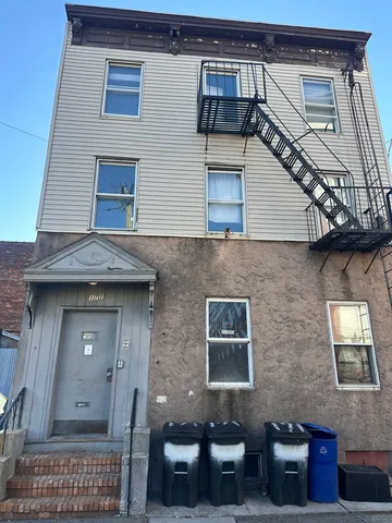 a view of a brick house with many windows