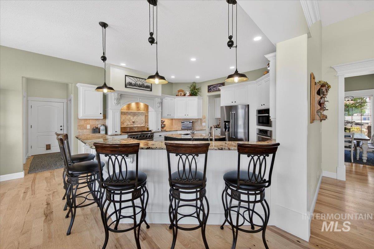 414 East Shafer View Drive Meridian, ID 83642 - Photo 8 of 50 Kitchen Breakfast Bar seats 6 and has Pendant lighting!