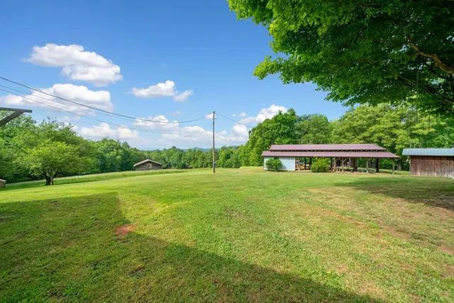 an aerial view of a house with garden space and lake view