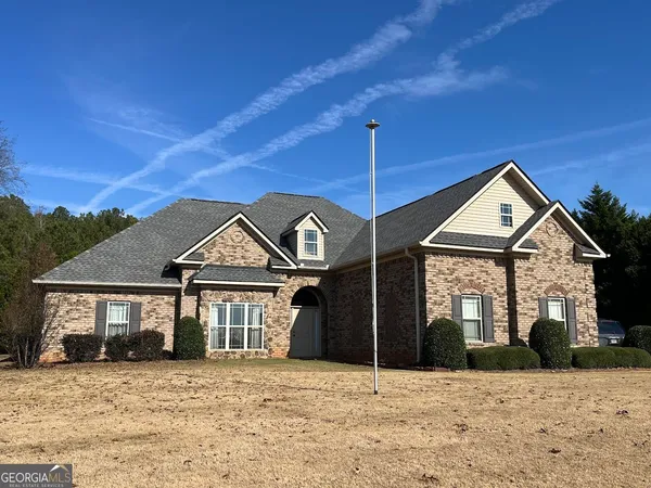 a front view of a house with a yard