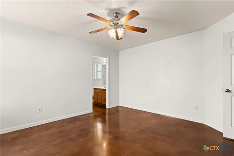 an empty room with closet and fan