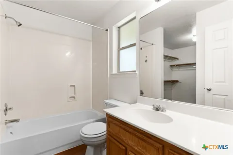 a bathroom with a sink toilet tub and shower