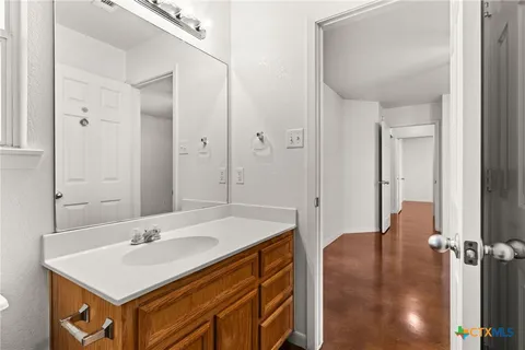 a bathroom with a sink vanity and a mirror