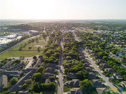an aerial view of residential houses with city view