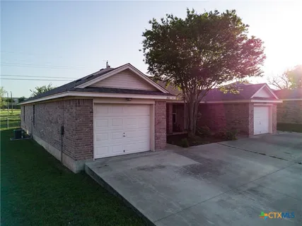 a front view of house with yard and trees