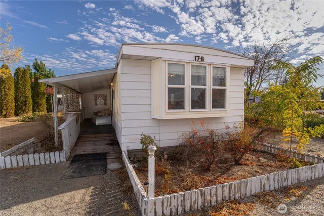 a view of a house with wooden fence