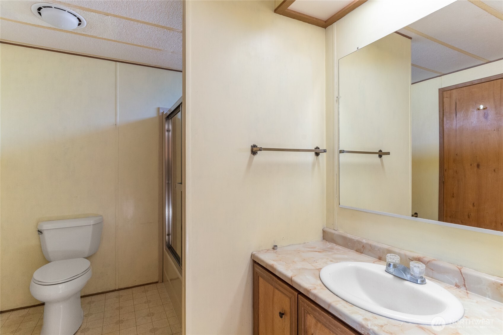52 Engh Road, Unit 17B Omak, WA 98841 - Photo 13 of 27 a bathroom with a sink toilet and vanity