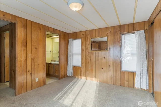 a view of a bathroom with shower and windows