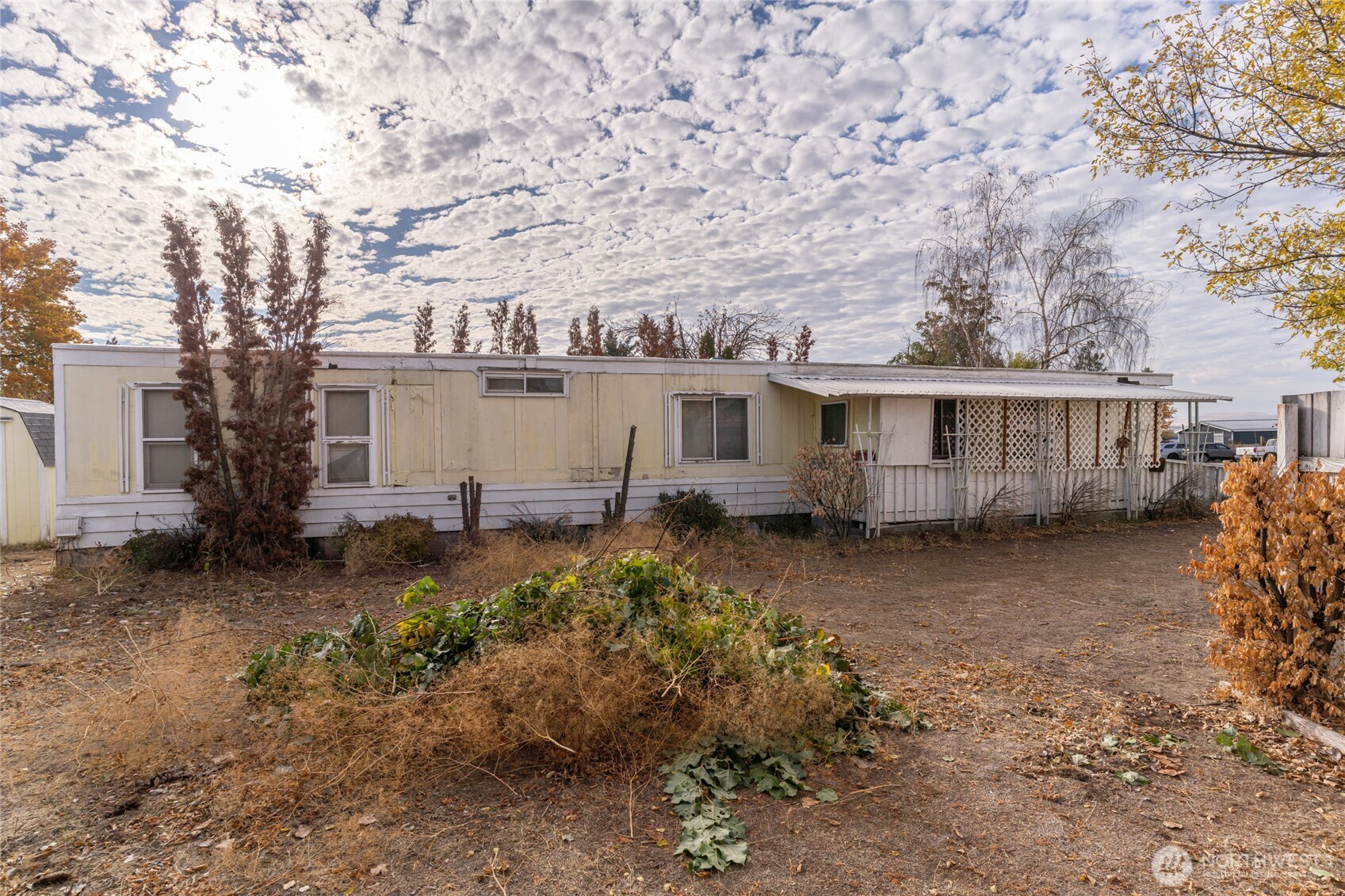 52 Engh Road, Unit 17B Omak, WA 98841 - Photo 2 of 27 a view of a house with a yard and large tree