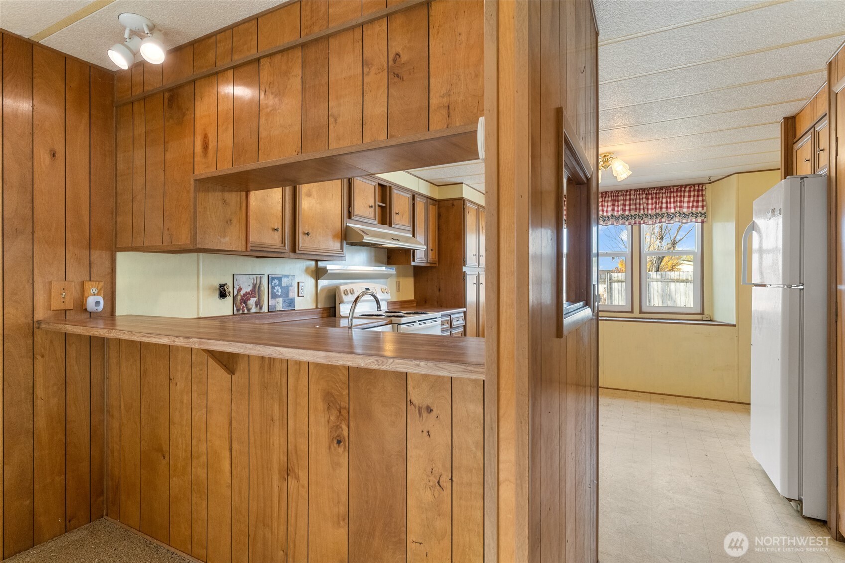 52 Engh Road, Unit 17B Omak, WA 98841 - Photo 8 of 27 a kitchen with stainless steel appliances granite countertop a refrigerator and a sink