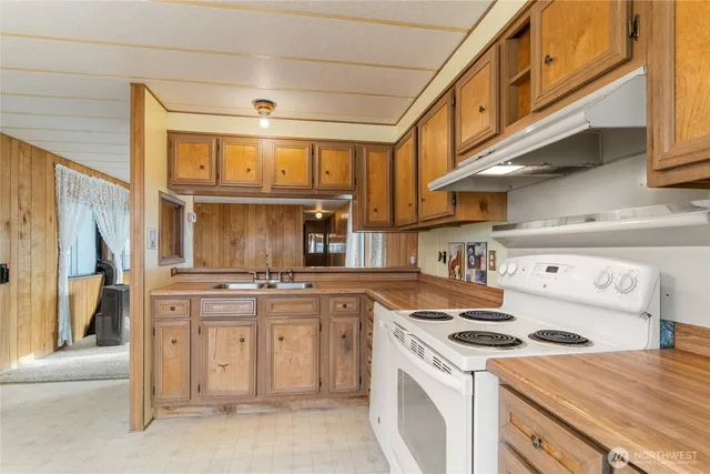 a kitchen with stainless steel appliances granite countertop a stove and a refrigerator
