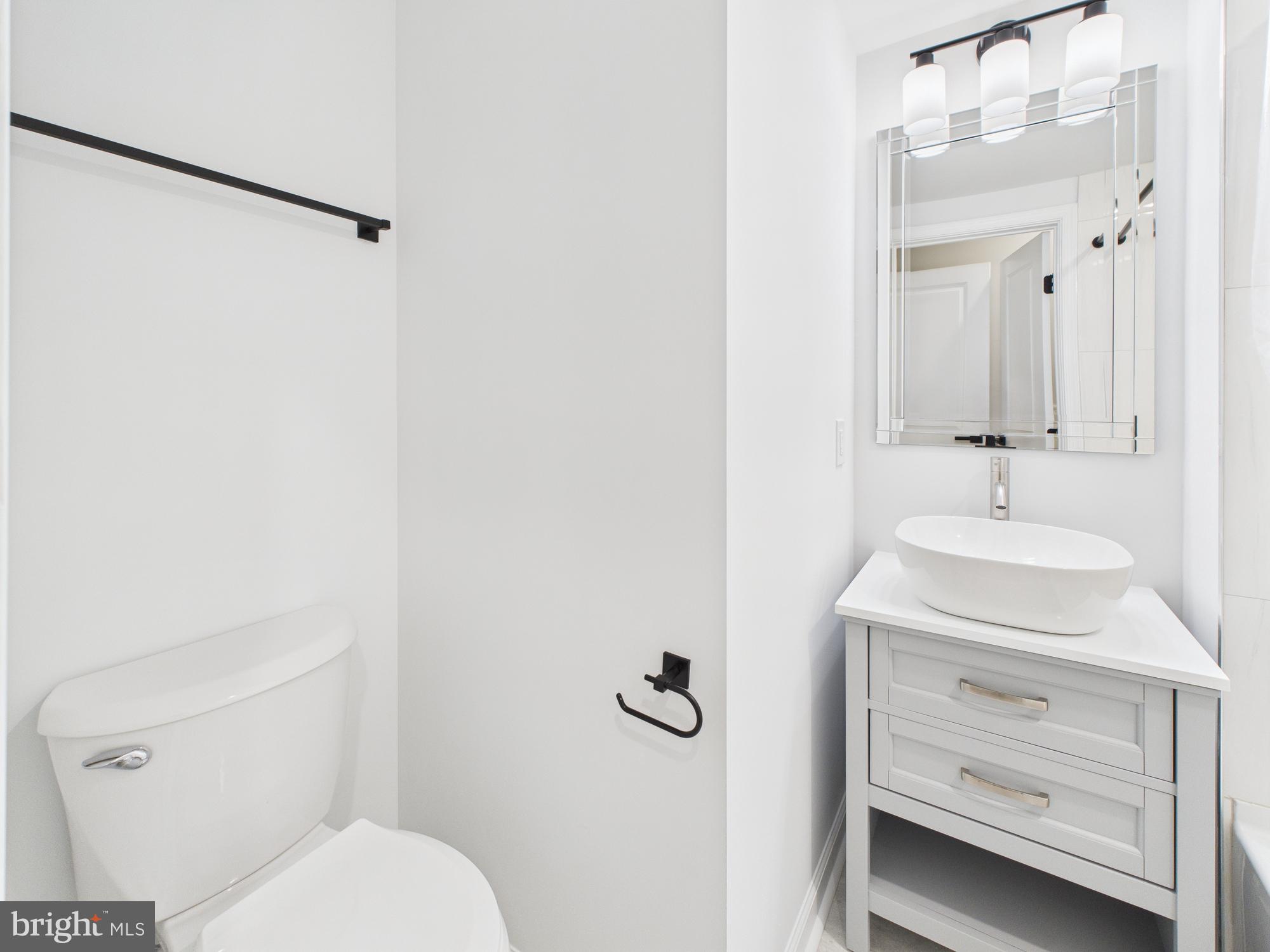 1320 Grove Street, Unit 1 Philadelphia, PA 19146 - Photo 3 of 15 a bathroom with a sink a toilet and shower