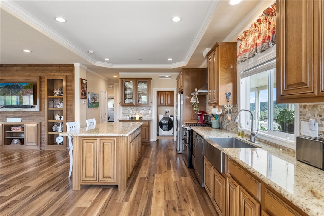 46430 De Portola Road Temecula, CA 92592 - Photo 12 of 61 a kitchen with stainless steel appliances granite countertop lots of counter top space and wooden floors