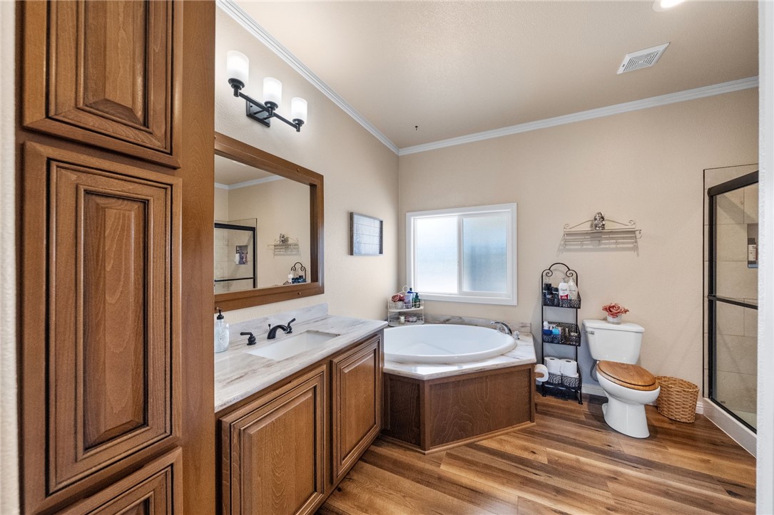 46430 De Portola Road Temecula, CA 92592 - Photo 24 of 61 a spacious bathroom with a double vanity sink a mirror and a bathtub
