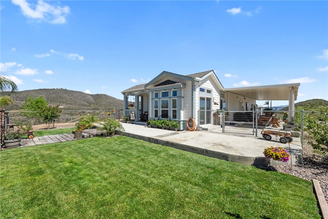 46430 De Portola Road Temecula, CA 92592 - Photo 59 of 61 a front view of a house with a garden and plants