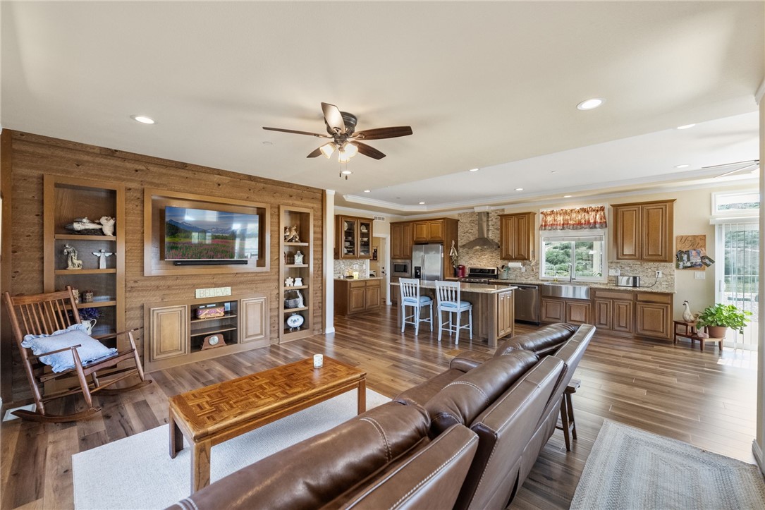 46430 De Portola Road Temecula, CA 92592 - Photo 8 of 61 a living room with furniture a flat screen tv and a table