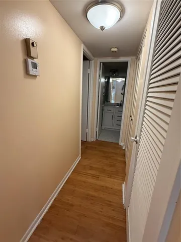 a view of a room with wooden floor