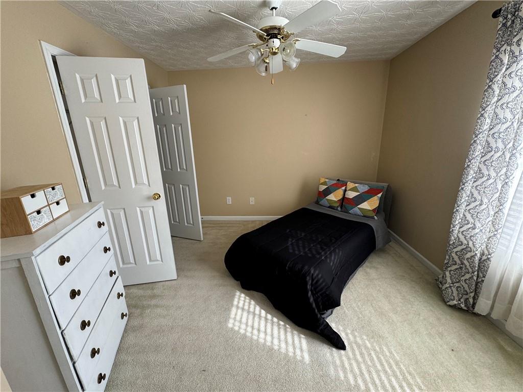 801 Old Peachtree Road Northwest, Unit 8 Lawrenceville, GA 30043 - Photo 12 of 26 a bedroom with a bed and a mirror