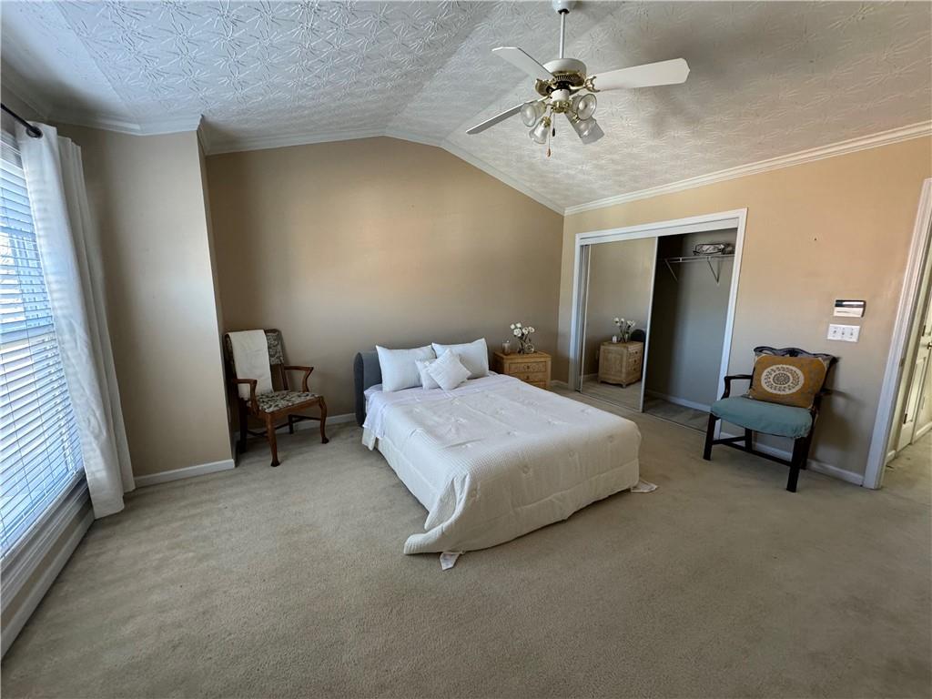 801 Old Peachtree Road Northwest, Unit 8 Lawrenceville, GA 30043 - Photo 15 of 26 a spacious bedroom with a bed and a chandelier